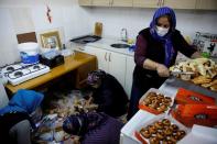 Members of local Alevi community prepare food to eat at the end of a cem in Istanbul