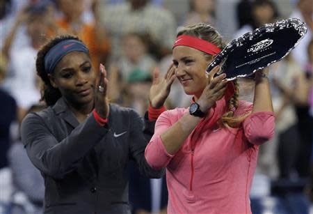 Serena Williams of the U.S. applauds as Victoria Azarenka of Belarus holds the runner up trophy after Williams won their women's singles final match at the U.S. Open tennis championships in New York September 8, 2013. REUTERS/Eduardo Munoz