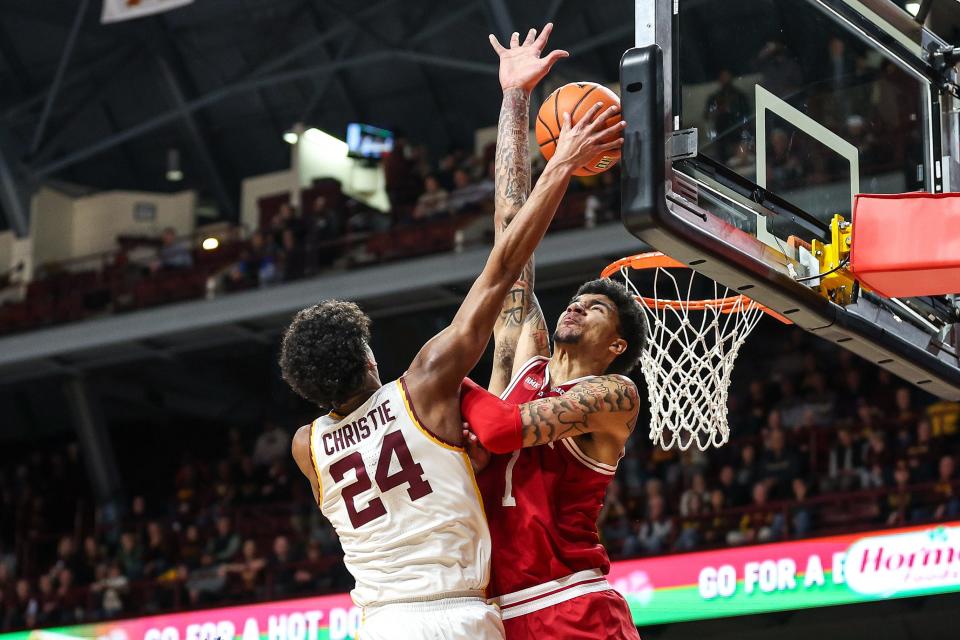 Mar 6, 2024; Minneapolis, Minnesota, USA; Minnesota Golden Gophers guard Cam Christie (24) shoots as Indiana Hoosiers center Kel'el Ware (1) defends during the first half at Williams Arena. Mandatory Credit: Matt Krohn-USA TODAY Sports