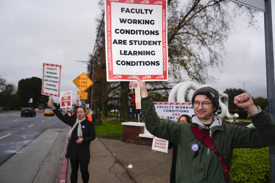 Demonstrators picket outside the Cal State Northridge campus Monday, Jan. 22, 2024, in Northridge, Calif. More than 30,000 professors, librarians, plumbers, electricians, and other workers at California State University, the largest public university system in the U.S., have started a weeklong strike on Monday to demand higher wages. (AP Photo/Marcio Jose Sanchez)