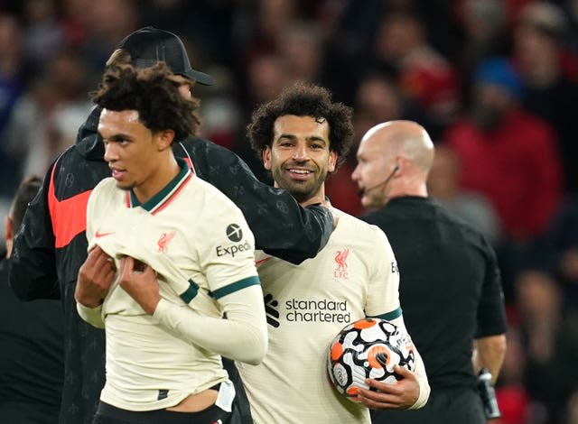 Liverpool hat-trick scorer Mohamed Salah celebrates with the match ball