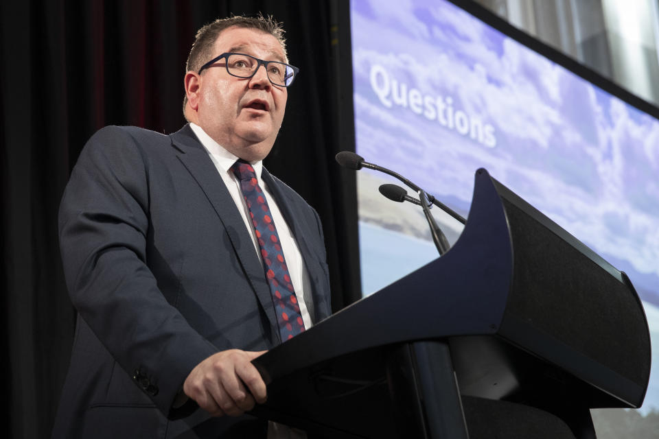 New Zealand Finance Minister Grant Robertson appears during his presentation at the Budget lockup in Wellington, New Zealand, Thursday, May 19, 2022. New Zealand's government said Thursday it will hand out an extra few hundred dollars to about half of all adults to help them navigate what it describes as "the peak of the global inflation storm." (Mark Mitchell/NZ Herald via AP)