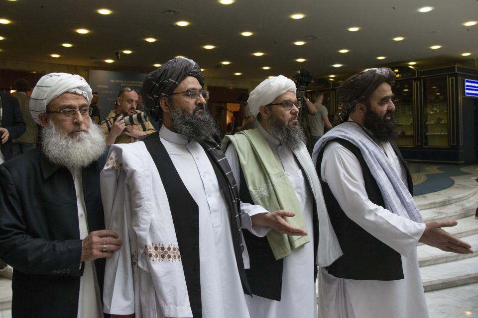 FILE - In this file photo taken on Tuesday, May 28, 2019, Mullah Abdul Ghani Baradar, the Taliban group's top political leader, second from left, arrives with other members of the Taliban delegation for talks in Moscow, Russia. The seventh and latest round of peace talks between the U.S. and Taliban is "critical," said Taliban spokesman Suhail Shaheen on Sunday, June 30, 2019, the second day of talks with Washington's peace envoy Zalmay Khalilzad in the Mideastern state of Qatar, where the militant group maintains a political office. (AP Photo/Alexander Zemlianichenko, File)