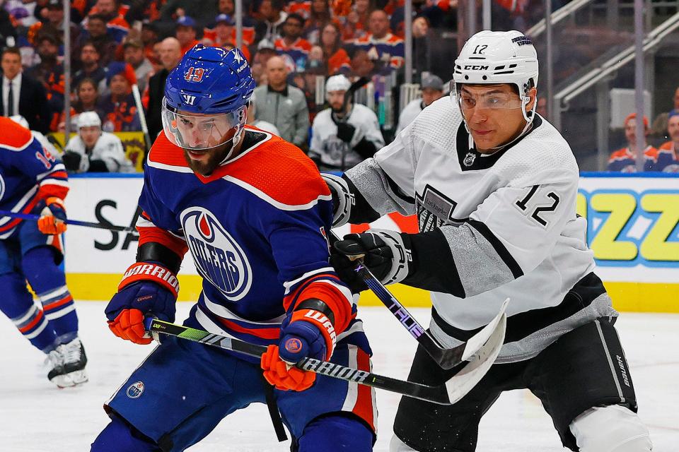 Los Angeles Kings forward Trevor Moore (right) battles Edmonton Oilers forward Adam Henrique for a loose puck during Game 1 of the Western Conference first-round playoffs on Monday in Edmonton.