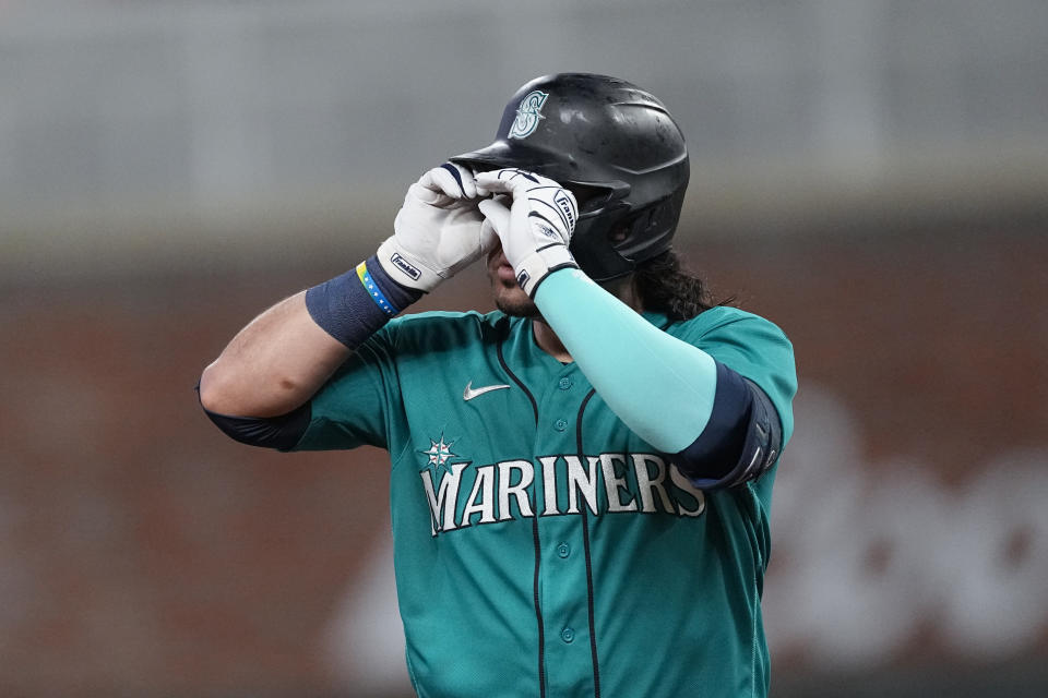 Seattle Mariners' Eugenio Suarez gestures as he runs the bases after hitting a two-run home run in the seventh inning of a baseball game against the Atlanta Braves, Saturday, May 20, 2023, in Atlanta. (AP Photo/John Bazemore)