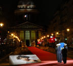 Pictures of Josephine Baker adorn the red carpet as the coffin with soils from the U.S., France and Monaco is carried towards the Pantheon monument in Paris, France, Tuesday, Nov. 30, 2021, where Baker is to symbolically be inducted, becoming the first Black woman to receive France's highest honor. Her body will stay in Monaco at the request of her family. (AP Photo/Christophe Ena)