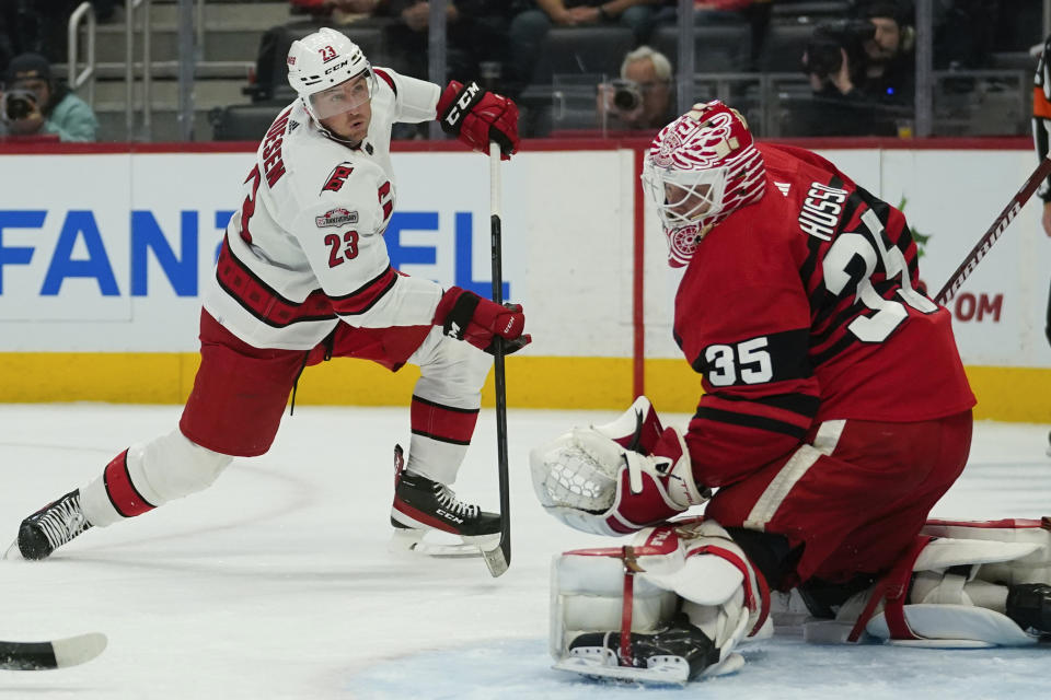 Detroit Red Wings goaltender Ville Husso (35) stops a Carolina Hurricanes right wing Stefan Noesen (23) shot in the first period of an NHL hockey game Tuesday, Dec. 13, 2022, in Detroit. (AP Photo/Paul Sancya)