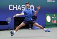 Novak Djokovic, of Serbia, returns a shot to Roberto Carballes Baena, of Spain, during the first round of the US Open tennis tournament Monday, Aug. 26, 2019, in New York. (AP Photo/Frank Franklin II)