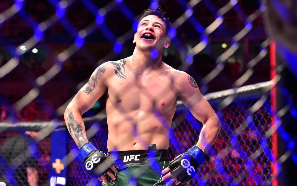 Jan 21, 2023; Rio de Janeiro, Brazil; Brandon Moreno (blue gloves) reacts after the fight against Deiveson Figueiredo (red gloves) during UFC 283 at Jeunesse Arena. Mandatory Credit: Jason da Silva-USA TODAY Sports