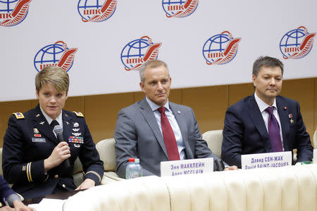 Crew members of the International Space Station (ISS) next mission David Saint-Jacques (C) of Canada, Oleg Kononenko (R) of Russia and Anne McClain of the U.S. attend a news conference in Star City near Moscow, Russia November 15, 2018. REUTERS/Maxim Shemetov