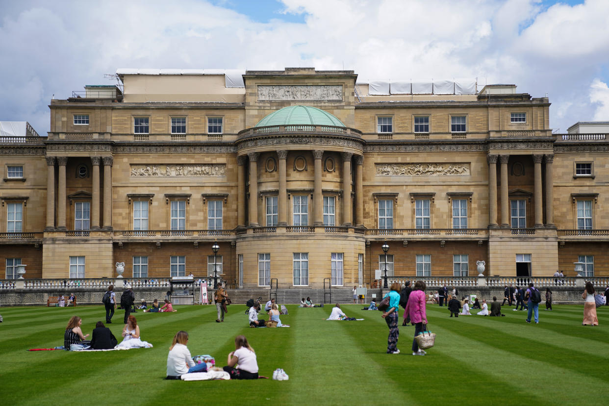 Visitors enjoy picnics on the lawn during a preview of the Garden at Buckingham Palace, Queen Elizabeth II's official residence in London, which opens to members of the public on Friday. Visitors will be able to picnic in the garden and explore the open space for the first time. Picture date: Thursday July 8, 2021. (Photo by Kirsty O'Connor/PA Images via Getty Images)