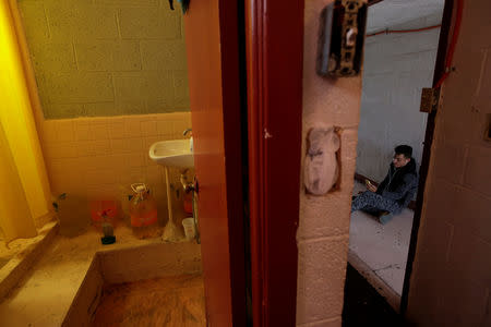 A Cuban migrant, waiting for their appointment to request asylum in the U.S., uses his phone outside his hotel room, in Ciudad Juarez, Mexico, April 1, 2019. REUTERS/Jose Luis Gonzalez