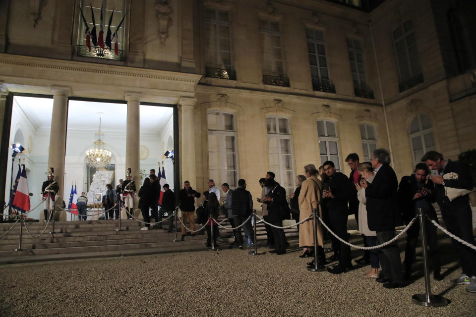 People line up to sign the condolences book to pay tribute to former President Jacques Chirac at the Elysee Palace, Thursday, Sept. 26, 2019. Jacques Chirac, a two-term French president who was the first leader to acknowledge France's role in the Holocaust and defiantly opposed the U.S. invasion of Iraq in 2003, has died Thursday at age 86. (AP Photo/Michel Euler)