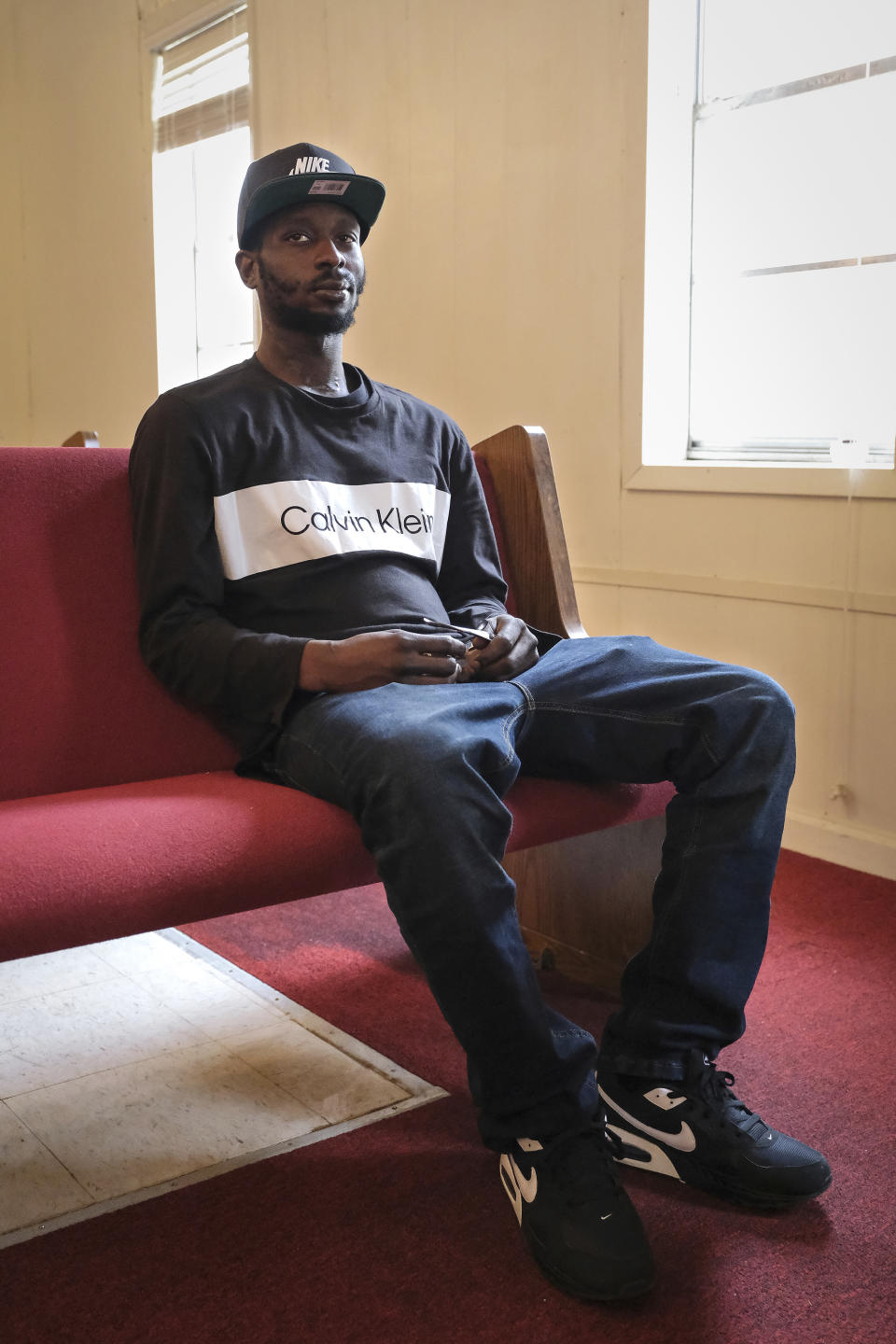 Michael Corey Jenkins sits on a pew in Taylor Hill Church in Braxton, Miss., on Saturday, March 18, 2023. The police shooting of Jenkins, who sustained critical injuries after he says a deputy put a gun in his mouth and fired, led the Justice Department to open a civil rights investigation into the Rankin County Sheriff's Office. Deputies said Jenkins was shot after he pointed a gun at them. (AP Photo/HG Biggs)