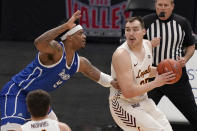 Loyola of Chicago's Cameron Krutwig, right, looks to pass as Drake's Darnell Brodie defends during the first half of the championship game in the NCAA Missouri Valley Conference men's basketball tournament Sunday, March 7, 2021, in St. Louis. (AP Photo/Jeff Roberson)