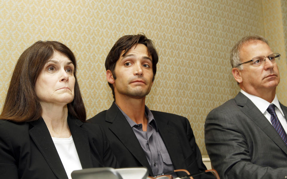 Plaintiff Michael Egan III, center, 31, his mother Bonnie Mound, left, and attorney Jeff Herman take questions from the media during a news conference in Beverly Hills, Calif., Monday, April 21, 2014. Egan, who previously accused “X-Men” director Bryan Singer of sexually abusing him when he was a teen, sued former TV programming executive Garth Ancier in Hawaii Monday accusing him of abuse in 1999 when Egan was 17. Egan also sued two other men in separate federal court lawsuits in Hawaii Monday, claiming they also abused him on trips there. (AP Photo/Nick Ut )