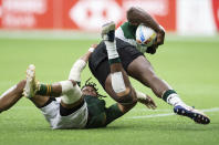 South Africa's Dewald Human, left, tackles Kenya's Harold Anduvate during an HSBC Canada Sevens rugby game in Vancouver, British Columbia, Saturday, Sept. 18, 2021. (Darryl Dyck/The Canadian Press via AP)