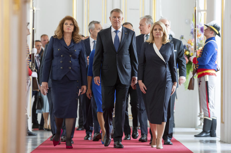 Slovakia's President Zuzana Caputova, right, Romania President Klaus Iohannis, centre, and Bulgaria Vice-President Iliana Iotova, left, arrive at the meeting of the leaders of the Bucharest Nine, a group of nine countries that make up the eastern flank of NATO, in Bratislava, Slovakia, Tuesday, June, 6, 2023. (Michal Svitok/TASR via AP)