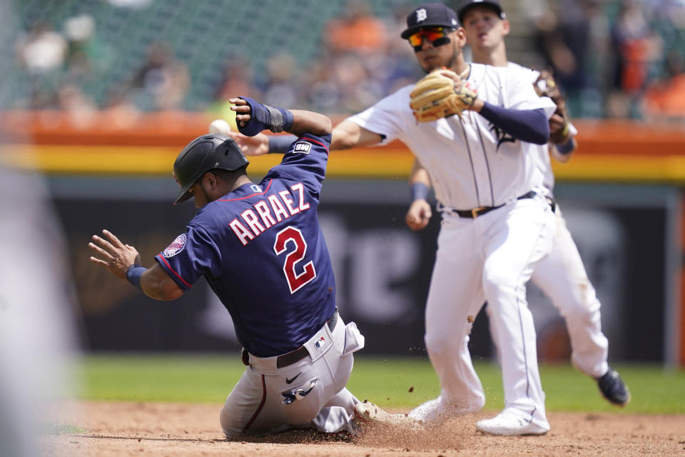 Minnesota Twins' Luis Arraez is out at second as teammate Josh Donaldson hits into a double play during the third inning of the first baseball game of a doubleheader, Saturday, July 17, 2021, in Detroit. (AP Photo/Carlos Osorio)