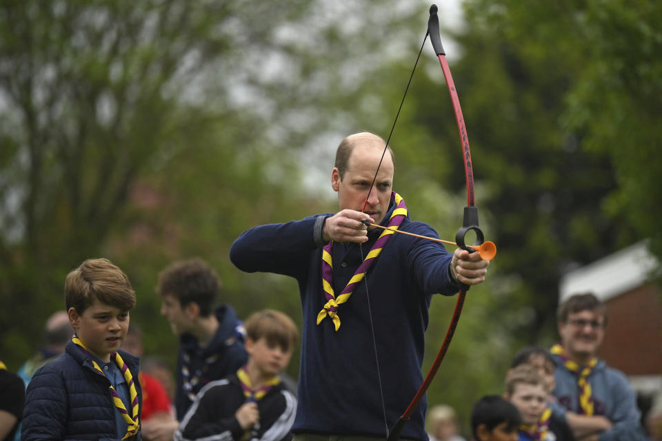 Britain's Prince William tries his hand at archery while taking part in the Big Help Out, during a visit to the 3rd Upton Scouts Hut in Slough, England, Monday, May 8, 2023. People across Britain were on Monday asked to do their duty as the celebrations for King Charles III's coronation drew to a close with a massive volunteering drive. (Daniel Leal/Pool Photo via AP)