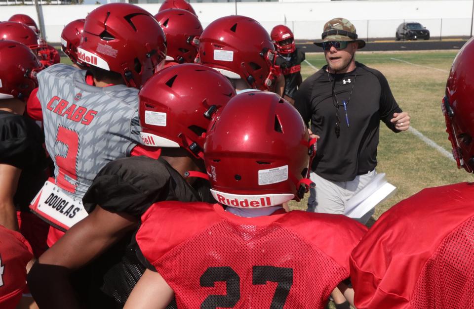 Seabreeze High's new head football coach Mike Klein talks with players, Monday May 6, 2024, during spring practice.