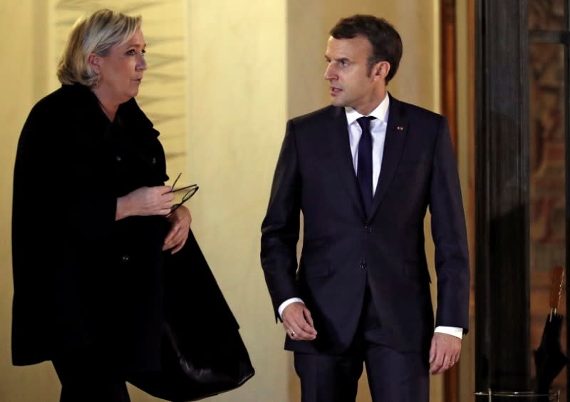 FILE PHOTO: French President Emmanuel Macron accompanies Marine Le Pen, head of France's far-right National Front (FN) following a meeting at the Elysee Palace in Paris