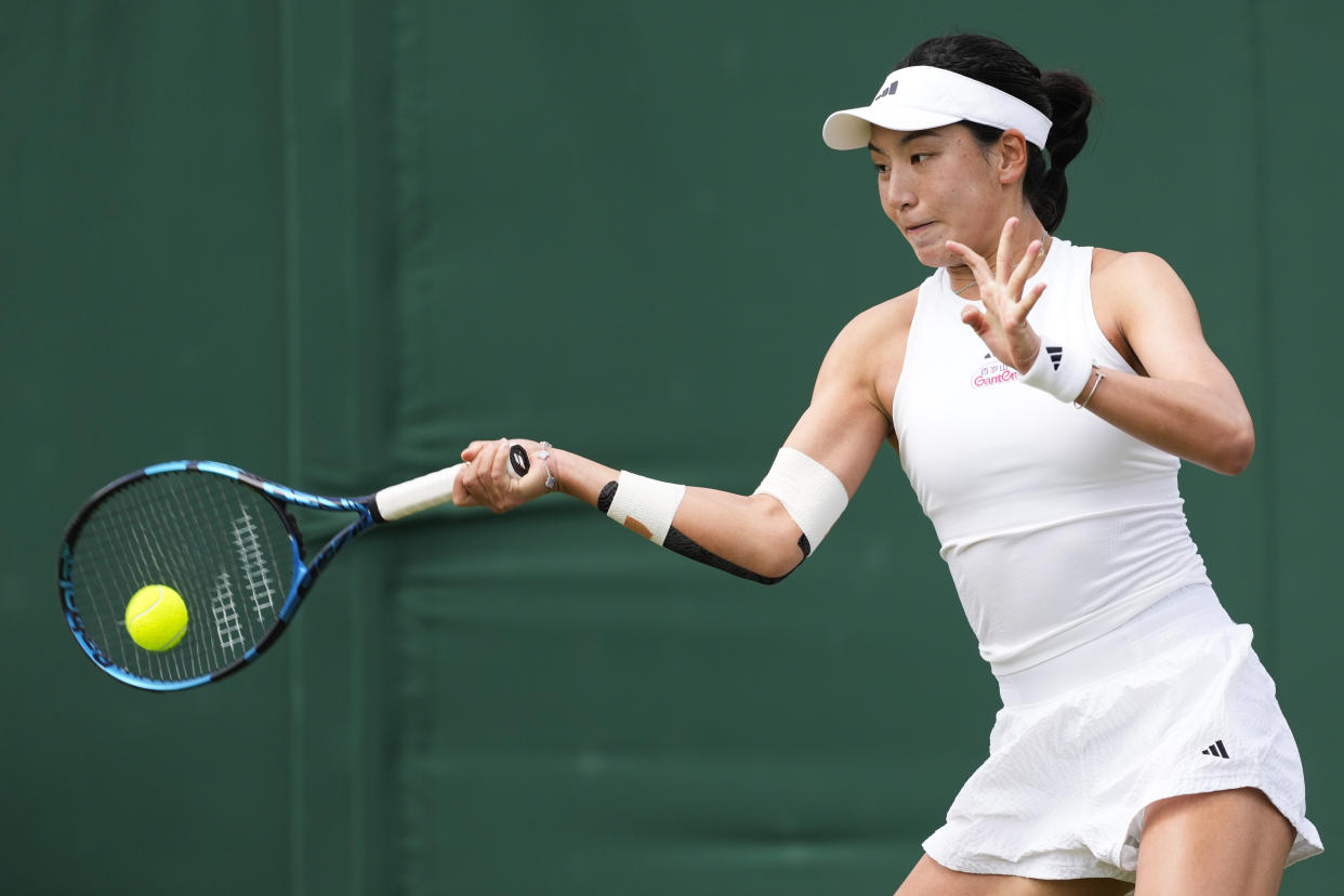 Xinyu Wang of China plays a forehand return to Jessica Pegula of the United States during their second round match at the Wimbledon tennis championships in London, Thursday, July 4, 2024. (AP Photo/Alberto Pezzali)