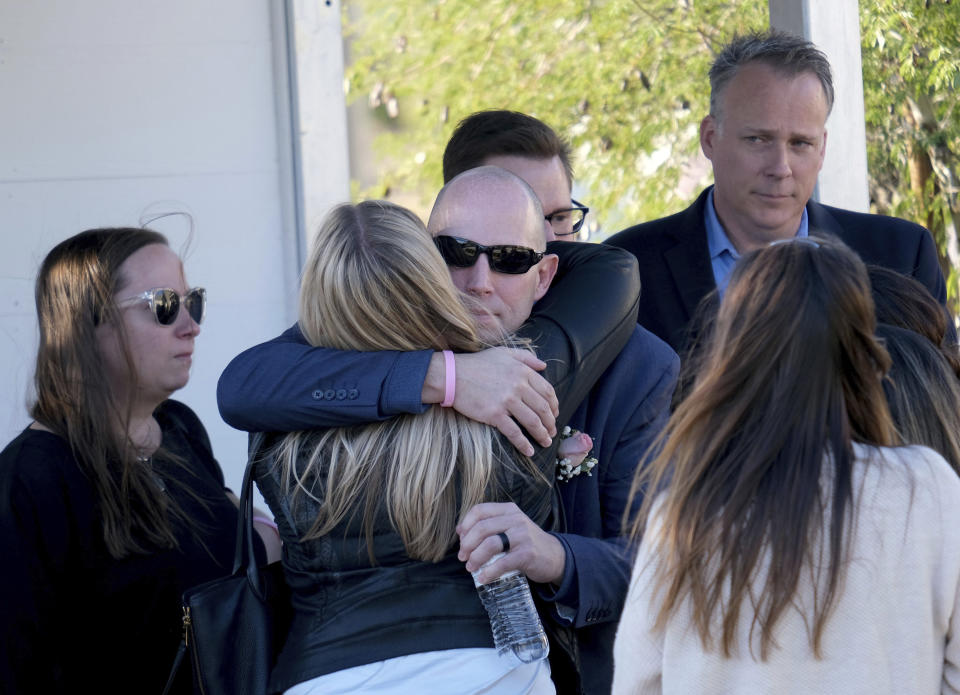 Bryan Muehlberger shares a hug following the memorial service for his daughter, Gracie Anne Muehlberger, 15, at Real Life Church, Saturday, Nov. 23, 2019, in Valencia, Calif. Muehlberger was one of two students killed Nov. 14, 2019, shooting at Saugus High School. (Dean Musgrove/The Orange County Register via AP)