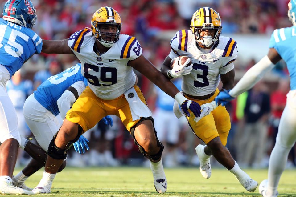 Sep 30, 2023; Oxford, Mississippi, USA; LSU Tigers running back Logan Diggs (3) runs the ball behind a block by LSU Tigers offensive linemen Charles Turner III (69) during the first quarter against the Mississippi Rebels at Vaught-Hemingway Stadium. Mandatory Credit: Petre Thomas-USA TODAY Sports