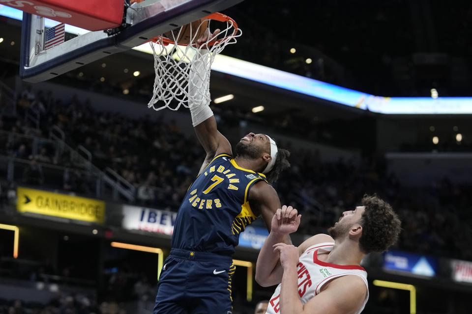 Indiana Pacers' Buddy Hield (7) dunks against Houston Rockets' Alperen Sengun (28) during the first half of an NBA basketball game, Tuesday, Feb. 6, 2024, in Indianapolis, (AP Photo/Darron Cummings)