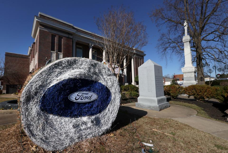 A hay bale painted with a Ford emblem sits outside the Haywood County Courthouse in Downtown Brownsville, Tenn. on Thursday, Dec. 23, 2021. The town square sits about 15 miles from the site of the Ford's Blue Oval City project, a $5.6 billion electric vehicle plant which the auto manufacturer expects to create nearly 6,000 jobs.