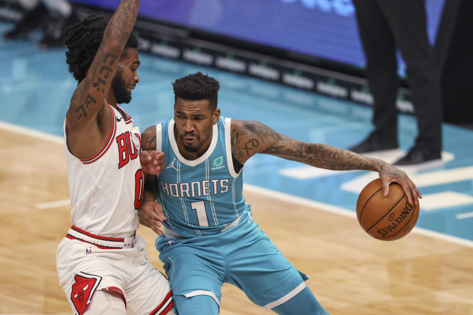 Charlotte Hornets guard Malik Monk, right, is defended by Chicago Bulls guard Coby White during the first quarter of an NBA basketball game in Charlotte, N.C., Thursday, May 6, 2021. (AP Photo/Nell Redmond)