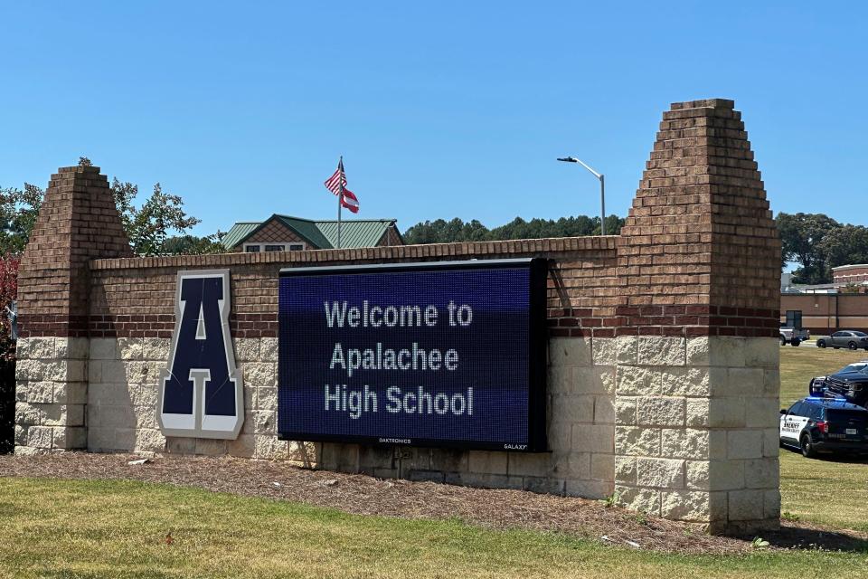 Law enforcement arrive as students are evacuated to the football stadium after the school campus was placed on lockdown at Apalachee High School in Winder, Ga., on Wednesday, Sept. 4, 2024. (AP Photo/Jeff Amy)