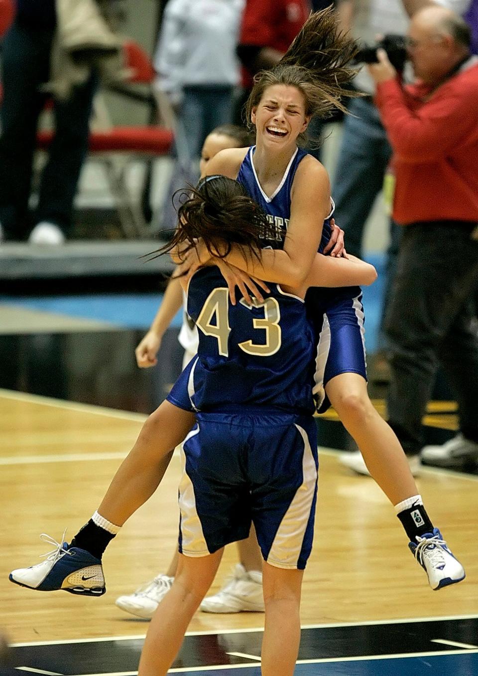 Whitefish Bay's Katie Wysocky (43) gives Meghan Warner a hug at the end of the game after Warner made the game-winning shot to beat Mosinee 45-44 in a WIAA girls Division 2 semifinal high school basketball game Friday, March 10, 2006, in Madison.