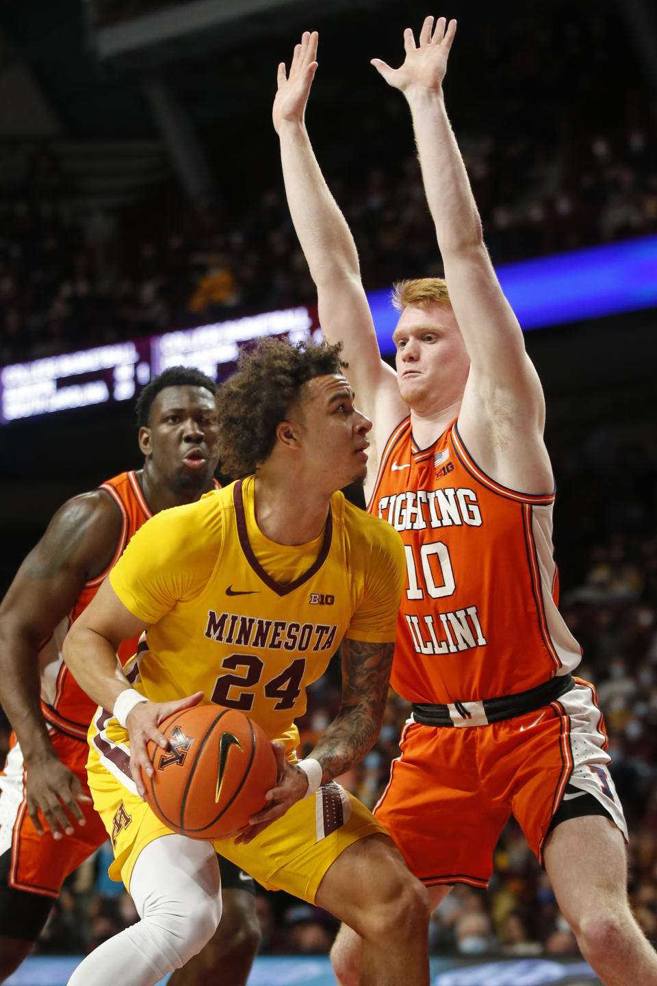 Minnesota guard Sean Sutherlin (24) looks to the basket as Illinois guard Luke Goode (10) defends during the first half of an NCAA college basketball game Tuesday, Jan. 4, 2022, in Minneapolis. (AP Photo/Bruce Kluckhohn)