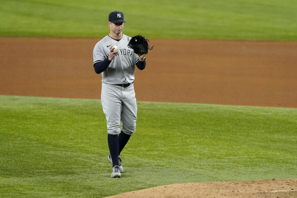 New York Yankees starting pitcher Corey Kluber calls for a fresh ball before throwing to Texas Rangers' Isiah Kiner-Falefa in the eighth inning of a baseball game in Arlington, Texas, Wednesday, May 19, 2021. (AP Photo/Tony Gutierrez)