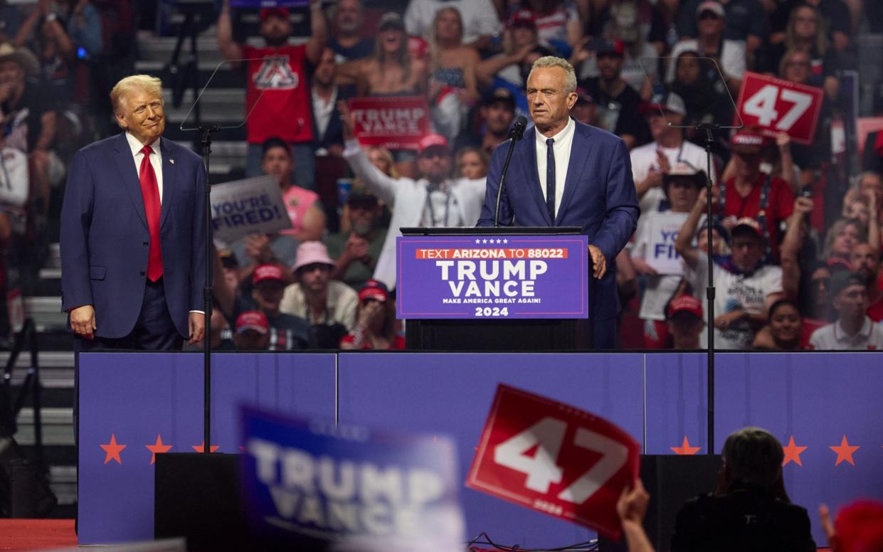 Donald Trump watches as Robert Kennedy speaks at the Arizona rally