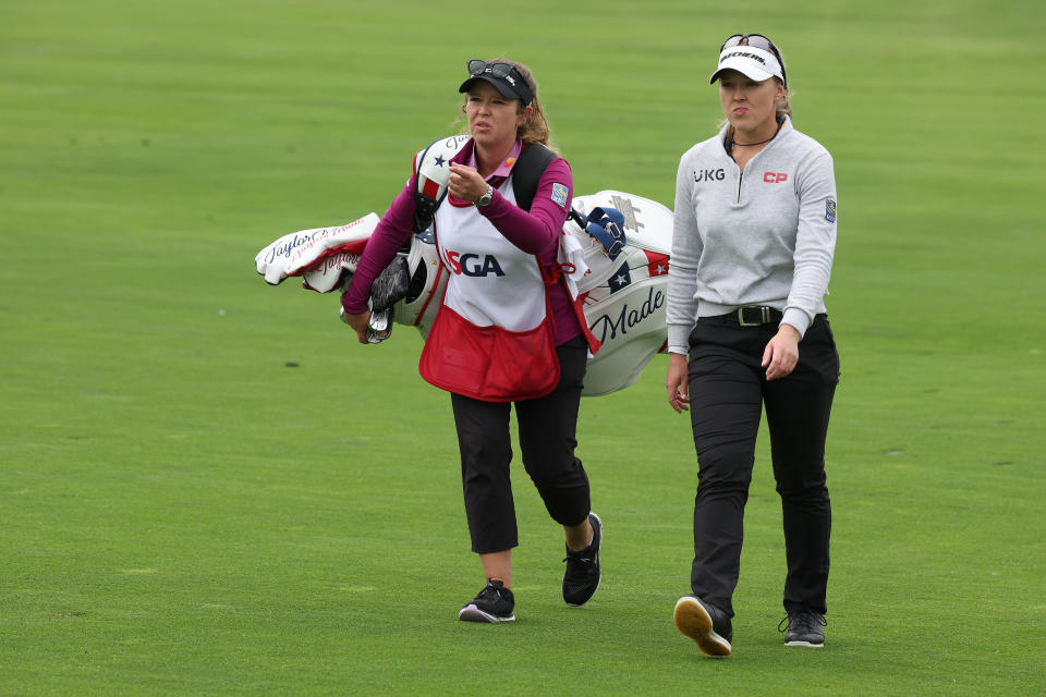 Brooke Henderson walks with her caddie