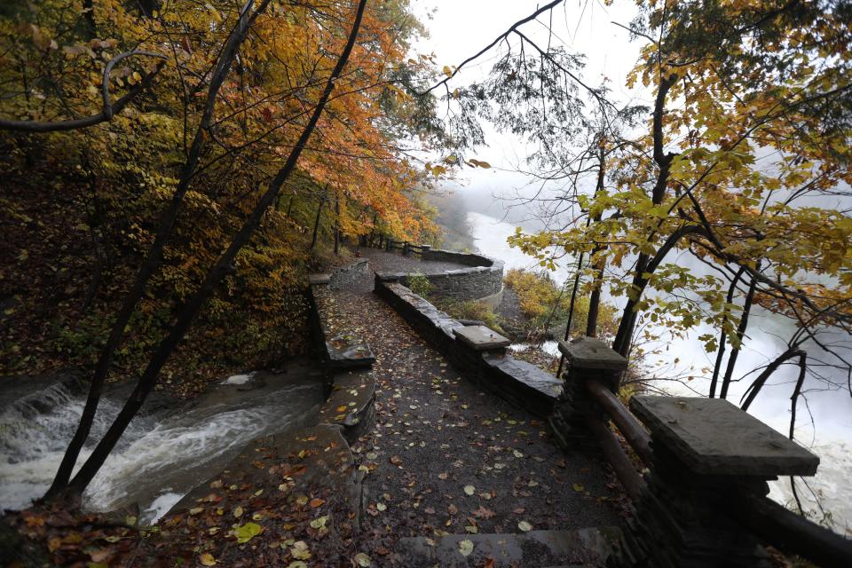 A stream, filled from the recent rains, pours its water into the Genesee River at the Upper Falls in Letchworth State Par, New York.