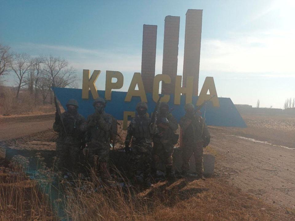 A picture released by Mr Prigozhin’s press service shows what it said to be Wagner fighters at the entrance sign to the village of Krasna Hora (Reuters)