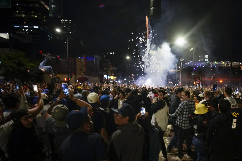 People celebrate after the Denver Nuggets won the NBA Championship with a victory over the Miami Heat in Game 5 of basketball's NBA Finals, Monday, June 12, 2023, in Denver. (AP Photo/David Zalubowski)