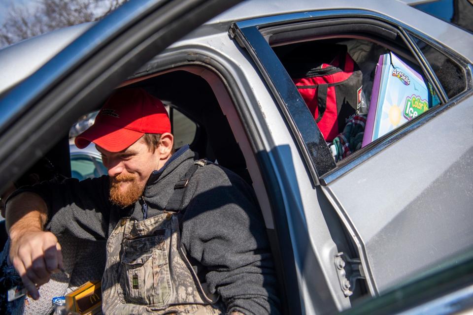 With his entire family's belonging packed up, Nathaniel Reed gets out of his car after getting some food for lunch for him and his family before meeting with Hotels For Homeless on Tuesday, Nov. 29, 2022. 