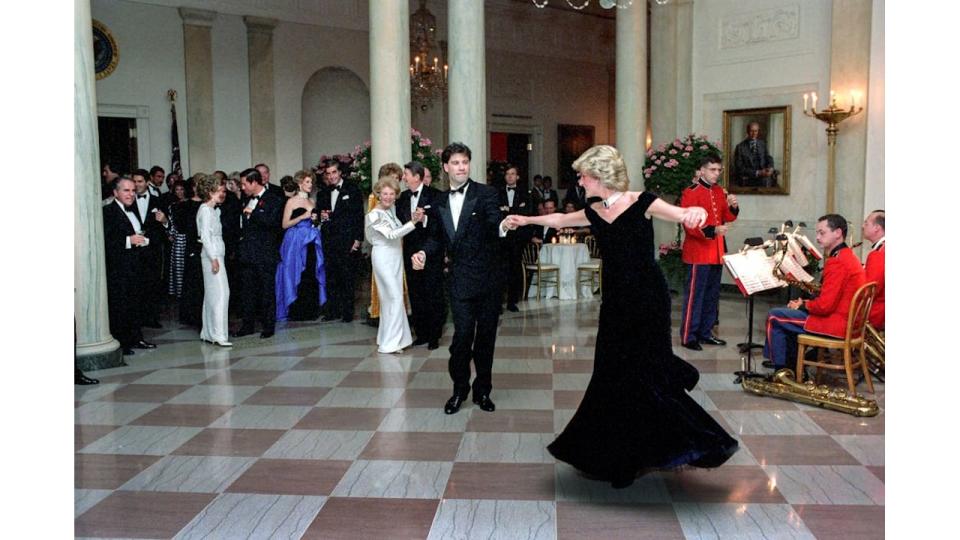 Princess Diana dances with John Travolta in Cross Hall at the White House during an official dinner on November 9, 1985 in Washington, DC