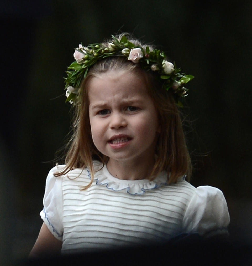 <p>His sister, Princess Charlotte, wore a flower crown and a short-sleeved white and blue bridesmaid dress. Photo: Australscope </p>