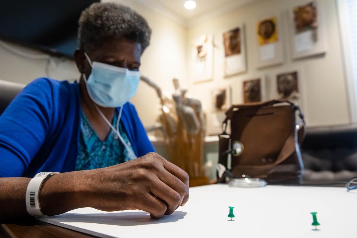 Lou Ellen Duncan uses push pins to help layout  her expressive shape Tuesday afternoon at the Savannah Center for the Blind and Low Vision.