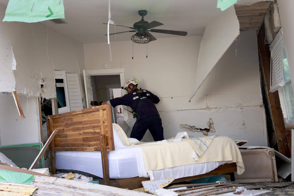 A member of a search and rescue team checks a home for victims in the wake of Hurricane Ian in Fort Myers Beach, Fla., on Oct. 3. (Joe Raedle / Getty Images)