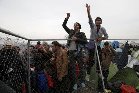 Migrants wait to cross the Greek-Macedonian border, near the village of Idomeni, Greece March 6, 2016. REUTERS/Marko Djurica