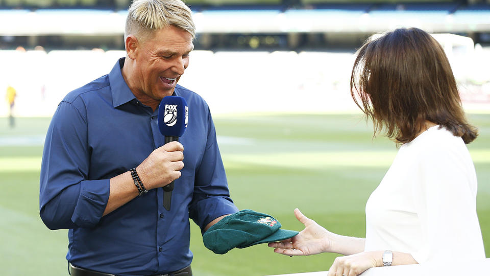 Shane Warne handed over his baggy green, after the Commonwealth Bank paid $1 million for it in a bushfire relief auction. (Photo by Daniel Pockett - CA/Cricket Australia via Getty Images )