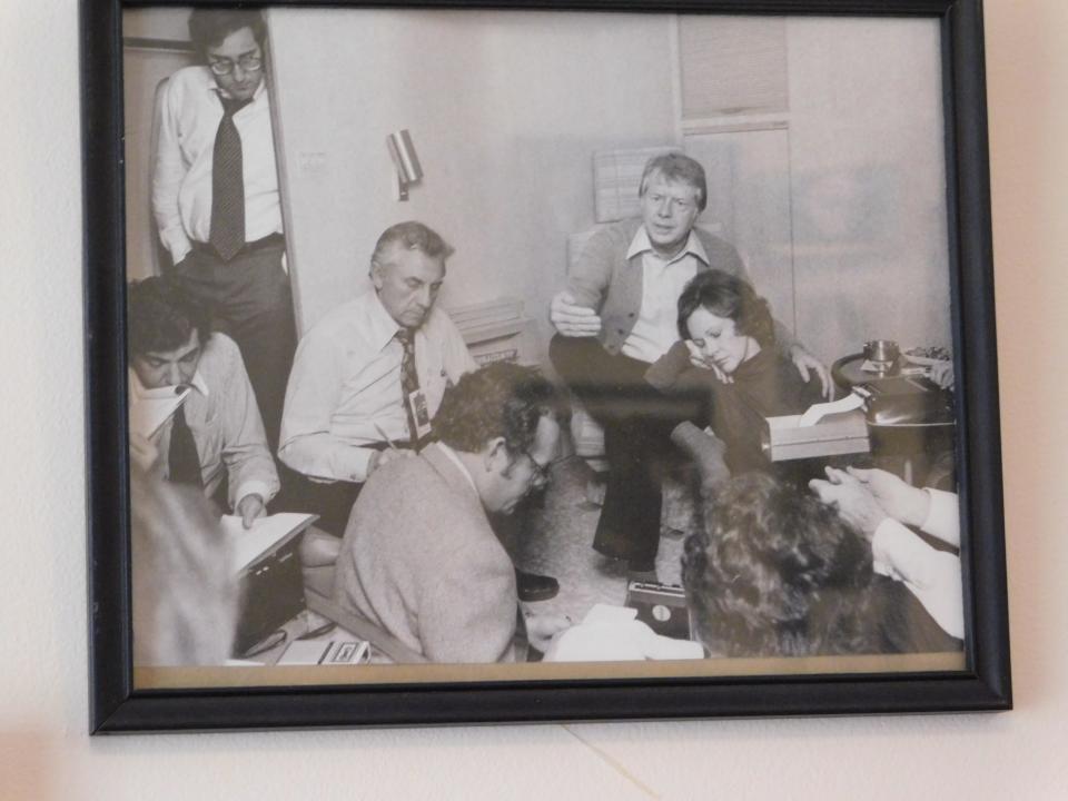 A photo hangs in Ted Knap's retirement home showing Knap, pictured left of former President Jimmy Carter, flies in Air Force One to one of the many international destinations he traveled to during the Carter administration. Former first lady Rosalynn Carter can be seen asleep on her husband's knee. The picture would later be seen on front pages around the world.