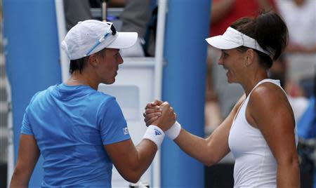 Casey Dellacqua of Australia (R) shakes hands with Kirsten Flipkens of Belgium after defeating her in their women's singles match at the Australian Open 2014 tennis tournament in Melbourne January 15, 2014. REUTERS/Bobby Yip